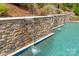 Custom pool with stacked-stone waterfalls for a luxurious backyard oasis at 221 N Centurion Ln, Mount Holly, NC 28120