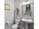 Elegant powder room with pedestal sink, stylish mirror, and neutral color scheme at 221 N Centurion Ln, Mount Holly, NC 28120
