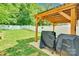 Backyard featuring a pergola, grill, green grass, and white fencing at 2662 14Th Ne St, Hickory, NC 28601