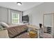 Cozy bedroom with a large window, neutral decor, and minimalist furniture arrangement at 2662 14Th Ne St, Hickory, NC 28601