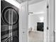 Close up of stacked washer and dryer in laundry area, with bedroom in the background at 2662 14Th Ne St, Hickory, NC 28601