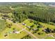 An aerial view of the neighborhood's homes, tree lined streets, and surrounding rural landscape at 2694 Rock Dam Rd, Lincolnton, NC 28092