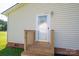 Back entrance features wooden steps and white door at 2694 Rock Dam Rd, Lincolnton, NC 28092