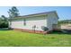 View of the backyard with green grass and partial view of the house at 2694 Rock Dam Rd, Lincolnton, NC 28092