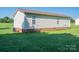 Backyard view showcasing a well-manicured lawn, part of home, and clear sky at 2694 Rock Dam Rd, Lincolnton, NC 28092