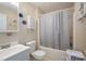 Clean bathroom with a combined bathtub and shower, toilet, and a vanity sink at 2694 Rock Dam Rd, Lincolnton, NC 28092