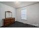 Bedroom featuring carpeted floors, a dresser, and natural light through the window at 2694 Rock Dam Rd, Lincolnton, NC 28092