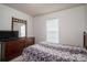 This bedroom features carpeted floors and a dresser with a mirror at 2694 Rock Dam Rd, Lincolnton, NC 28092