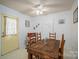 Eat-in dining area featuring ceiling fan, decorative door, and a wooden dining table at 2694 Rock Dam Rd, Lincolnton, NC 28092