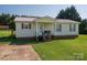Inviting single-story home with a charming porch and well-kept lawn, perfect for outdoor enjoyment at 2694 Rock Dam Rd, Lincolnton, NC 28092
