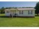 Quaint single-story home with a cozy porch and manicured lawn, ideal for comfortable living at 2694 Rock Dam Rd, Lincolnton, NC 28092