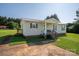 Charming single-story home with a cozy porch and a well-manicured front lawn at 2694 Rock Dam Rd, Lincolnton, NC 28092