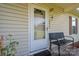 A front porch with a charming bench, plants, and a welcoming door with decorative accents at 2694 Rock Dam Rd, Lincolnton, NC 28092