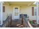 Close-up of a charming front porch with a bench and decorative plants by the door at 2694 Rock Dam Rd, Lincolnton, NC 28092