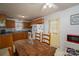 Eat-in kitchen featuring a rustic dining table, white appliances and access to back door at 2694 Rock Dam Rd, Lincolnton, NC 28092