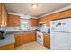 Charming kitchen with oak cabinets, white appliances, and a window view offering ample natural light and a cozy cooking space at 2694 Rock Dam Rd, Lincolnton, NC 28092