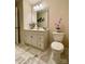 Bright bathroom featuring vanity, mirror, and floral decor accents at 2769 Sawbridge Ln, Gastonia, NC 28056