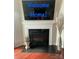 Cozy fireplace with a decorative mantle and a mounted television above at 2769 Sawbridge Ln, Gastonia, NC 28056