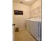 Functional laundry room with washer, dryer, and overhead shelving for storage at 2769 Sawbridge Ln, Gastonia, NC 28056