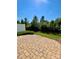 Brick patio surrounded by lush greenery and a black metal fence at 2769 Sawbridge Ln, Gastonia, NC 28056
