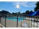 Community pool with lounge chairs and umbrellas under a sunny sky at 2769 Sawbridge Ln, Gastonia, NC 28056