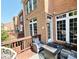Outdoor patio featuring a modern fire pit, gray seating, and overlooking the brick architecture at 3114 Luke Crossing Dr, Charlotte, NC 28226