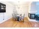 Elegant dining area with a modern chandelier, glass table, and access to living area at 3114 Luke Crossing Dr, Charlotte, NC 28226