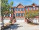 Charming brick townhome featuring a one-car garage, green shutters and a well-manicured front yard at 3114 Luke Crossing Dr, Charlotte, NC 28226