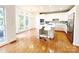 Eat-in kitchen with white cabinets, stainless steel appliances, granite countertops, and hardwood floors at 3114 Luke Crossing Dr, Charlotte, NC 28226