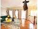 Bright living room featuring hardwood floors, large windows, and stylish furnishings at 3114 Luke Crossing Dr, Charlotte, NC 28226