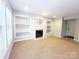 Bright living room with fireplace and built-in shelving at 3114 Luke Crossing Dr, Charlotte, NC 28226