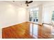 Bright living room with hardwood floors, ceiling fan, and large windows offering plenty of natural light at 3114 Luke Crossing Dr, Charlotte, NC 28226