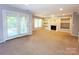 Open living room with fireplace, built-in shelves, windows and sliding glass doors to the outside at 3114 Luke Crossing Dr, Charlotte, NC 28226