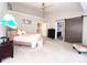 Spacious main bedroom with a sliding barn door, ceiling fan, and a bed with soft colored linens at 3114 Luke Crossing Dr, Charlotte, NC 28226