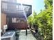 View of deck over outdoor patio with brick exterior and shrubbery at 3114 Luke Crossing Dr, Charlotte, NC 28226