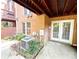 Covered outdoor patio featuring brick walls, a small garden, and direct access to the home's interior at 3114 Luke Crossing Dr, Charlotte, NC 28226
