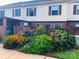 Backyard view of townhouse exterior featuring colorful flowerbed along the side at 4754 Old Lantern Way, Charlotte, NC 28212