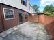 Exterior shot of a home backyard with a back door, red brick, and concrete at 4754 Old Lantern Way, Charlotte, NC 28212