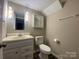 Functional bathroom with a vanity, mirror, toilet, and neutral color scheme at 4754 Old Lantern Way, Charlotte, NC 28212