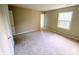 Bright bedroom with beige carpet, neutral walls, and a large window at 4754 Old Lantern Way, Charlotte, NC 28212