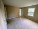 Spacious bedroom with neutral carpeting and ample natural light from a large window at 4754 Old Lantern Way, Charlotte, NC 28212