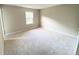 Cozy bedroom featuring beige carpet, neutral walls, and a bright window at 4754 Old Lantern Way, Charlotte, NC 28212