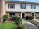 Charming townhome with brick and siding, featuring red shutters and well-maintained landscaping at 4754 Old Lantern Way, Charlotte, NC 28212