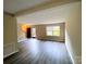 Open living room featuring new flooring, neutral walls, and lots of natural light at 4754 Old Lantern Way, Charlotte, NC 28212