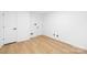 Simple bedroom with wood-look floors and neutral color scheme at 4808 Cobble Glen Way, Charlotte, NC 28269