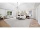 Spacious main bedroom with a tray ceiling, large windows, and a cozy seating area at 4808 Cobble Glen Way, Charlotte, NC 28269