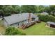 Aerial view of a large back yard with deck and luscious landscaping at 5006 Crooked Oak Ln, Charlotte, NC 28226