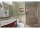 Updated bathroom with tiled shower, neutral walls, and traditional sink and vanity at 5006 Crooked Oak Ln, Charlotte, NC 28226