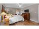 Relaxing bedroom features hardwood floors, natural light, and traditional furnishings at 5006 Crooked Oak Ln, Charlotte, NC 28226