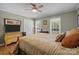 Comfortable bedroom featuring warm colors, natural light, and a ceiling fan at 5006 Crooked Oak Ln, Charlotte, NC 28226